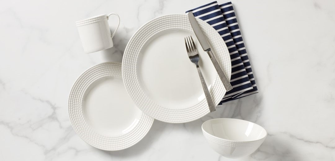 White dinnerware with blue striped napkin.
