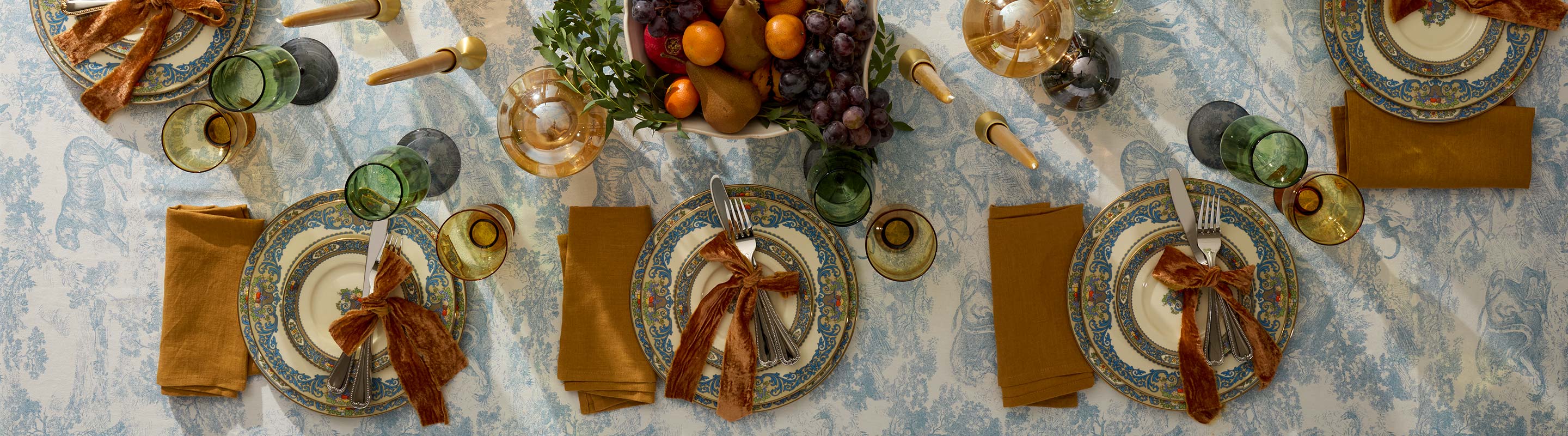Thanksgiving dinnerware and decor laid out on a table