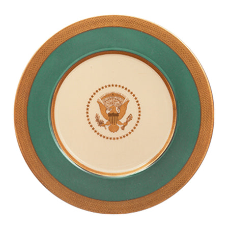 Cream porcelain plate with a green border, gold ornate rim, and a central Presidential Seal.