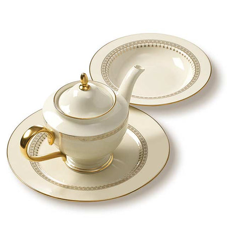 Porcelain teapot and plates with gold trim and geometric patterns