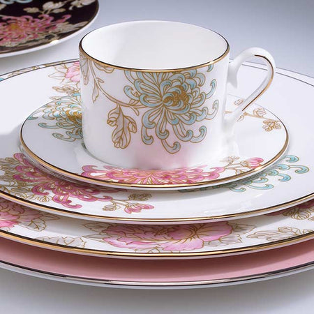 Formal white porcelain tea set featuring pink and blue floral designs with gold trim.