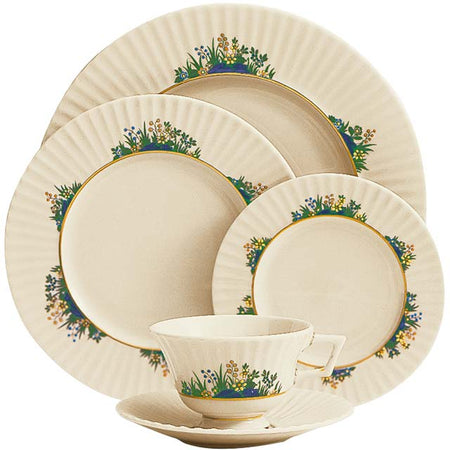 Cream dinnerware set with fluted edges and colorful wildflower motifs.