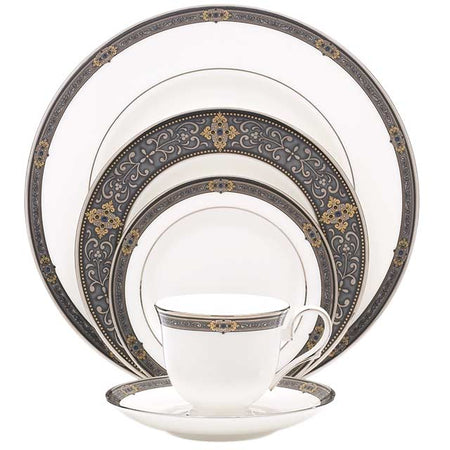 White dinnerware set with ornate grey and gold scrollwork borders.